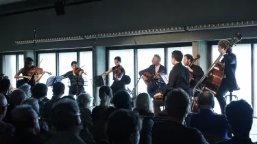 A group of musicians playing string instruments.